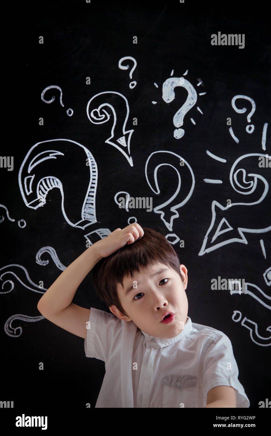 Primary school boy in thinking Stock Photo