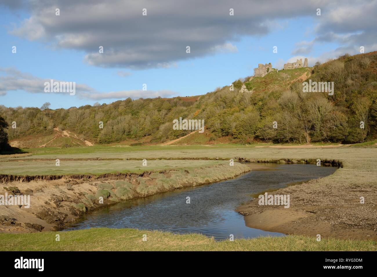 Meandering Pennard Pill stream overlooked by Pennard castle ruins, Three Cliffs Bay, The Gower peninsula, Wales, UK, October 2018. Stock Photo