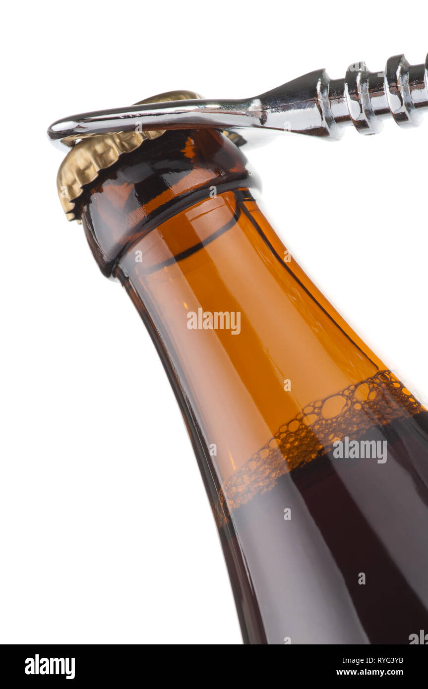 Opening dark beer bottle with metal opener Stock Photo