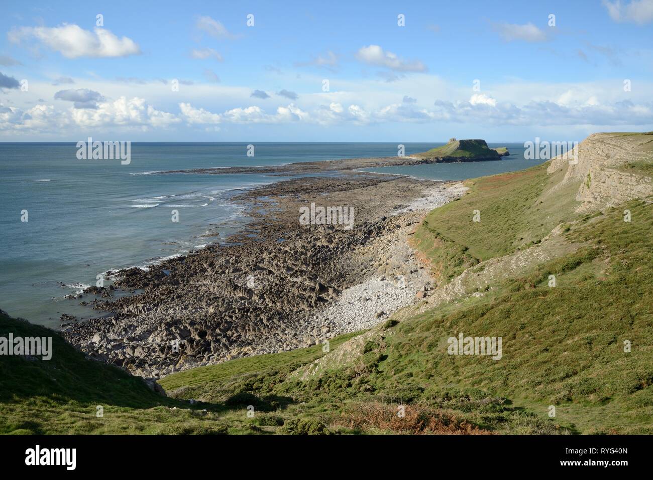 Overview of the Worm's head with the causeway that connects it to the mainland exposed at low tide, Rhossili, The Gower peninsula, Wales, UK, October  Stock Photo