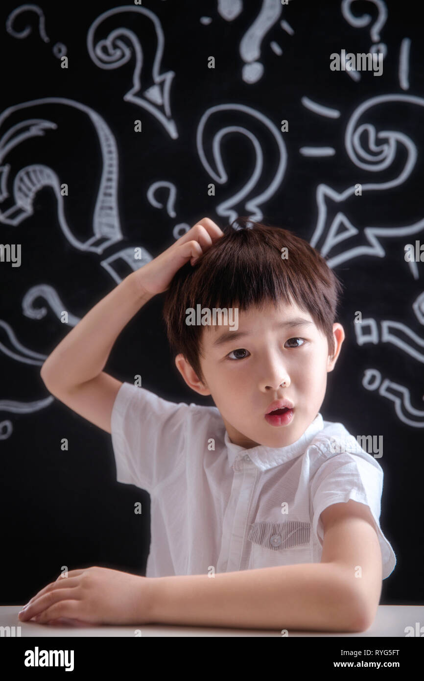 Primary school boy in thinking Stock Photo