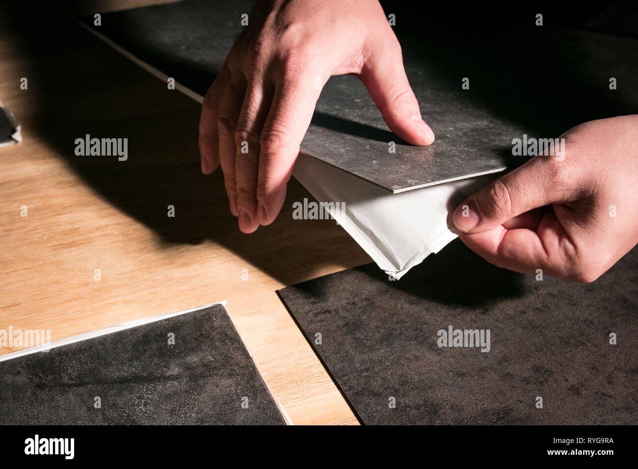 Removing Backing From Peel And Stick Vinyl Flooring Tiles Stock