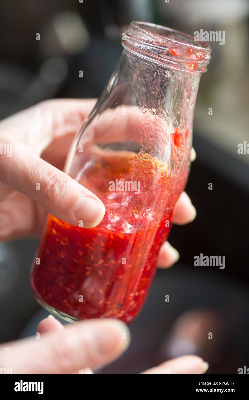 Preparing raspberry vinaigrette dressing Stock Photo
