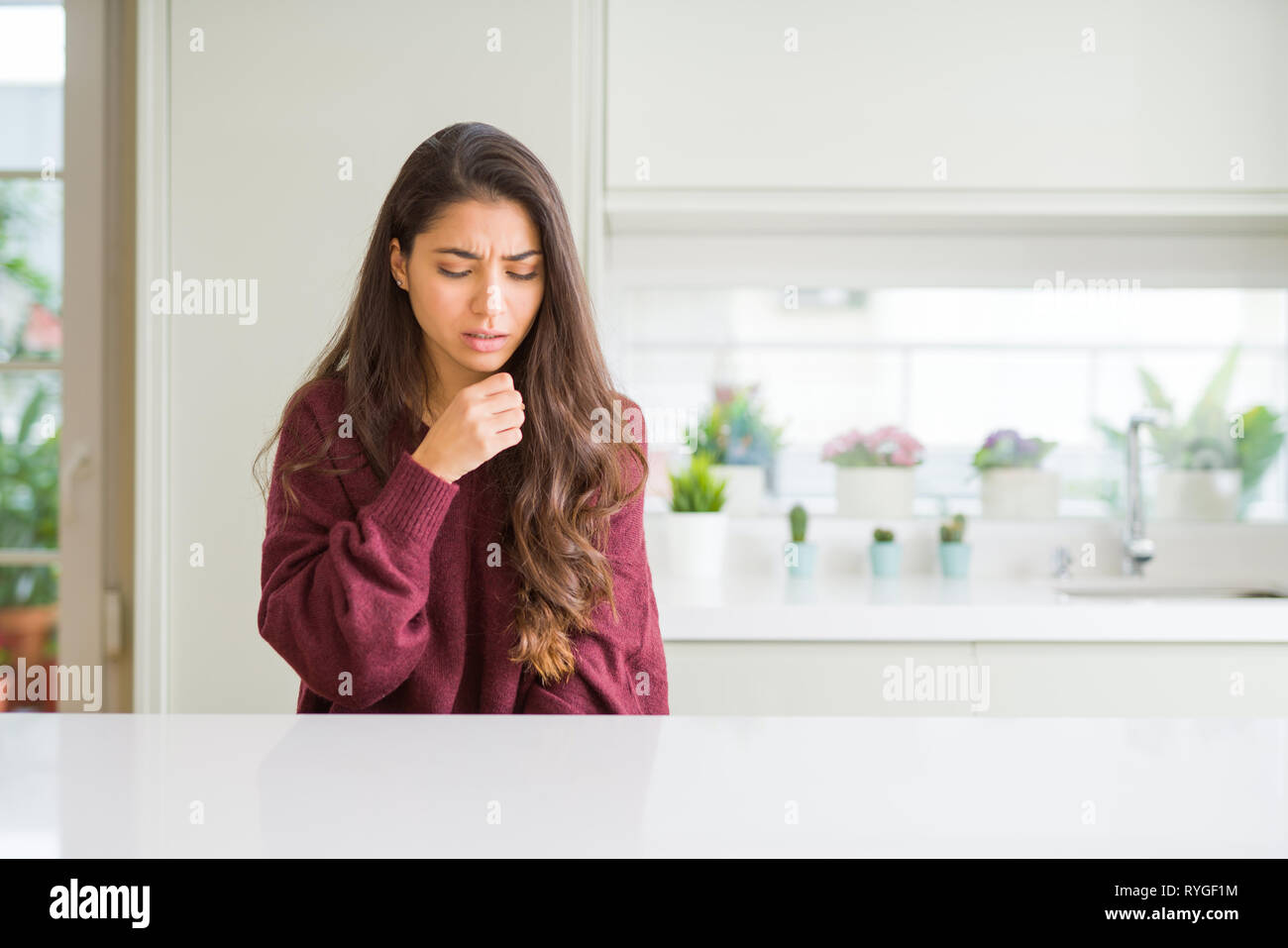 Young beautiful woman at home feeling unwell and coughing as symptom for cold or bronchitis. Healthcare concept. Stock Photo