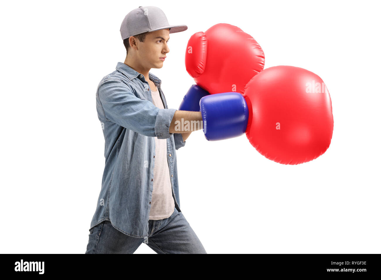 Young male with big red boxing gloves isolated on white background Stock Photo