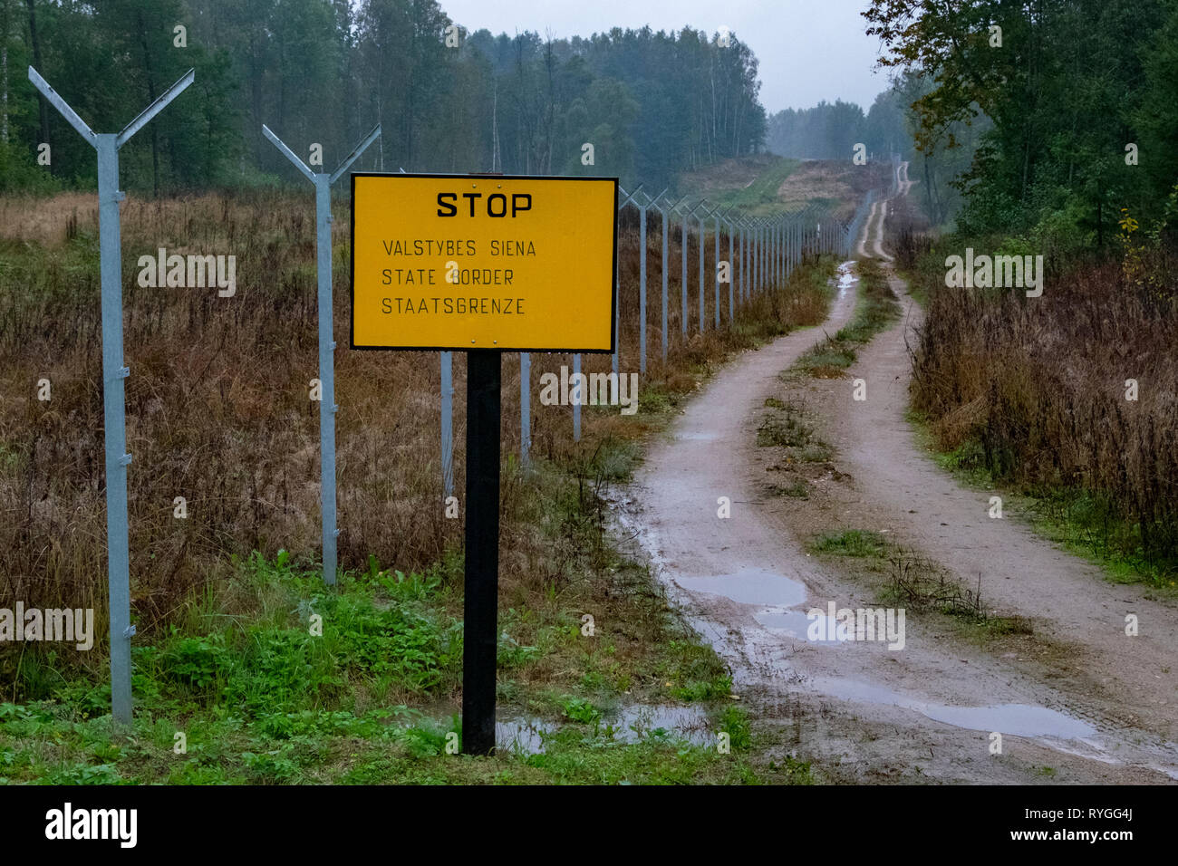 The Polish border with Kaliningrad, Russia and Lithuania and a sign & fence prohibitting entry Stock Photo