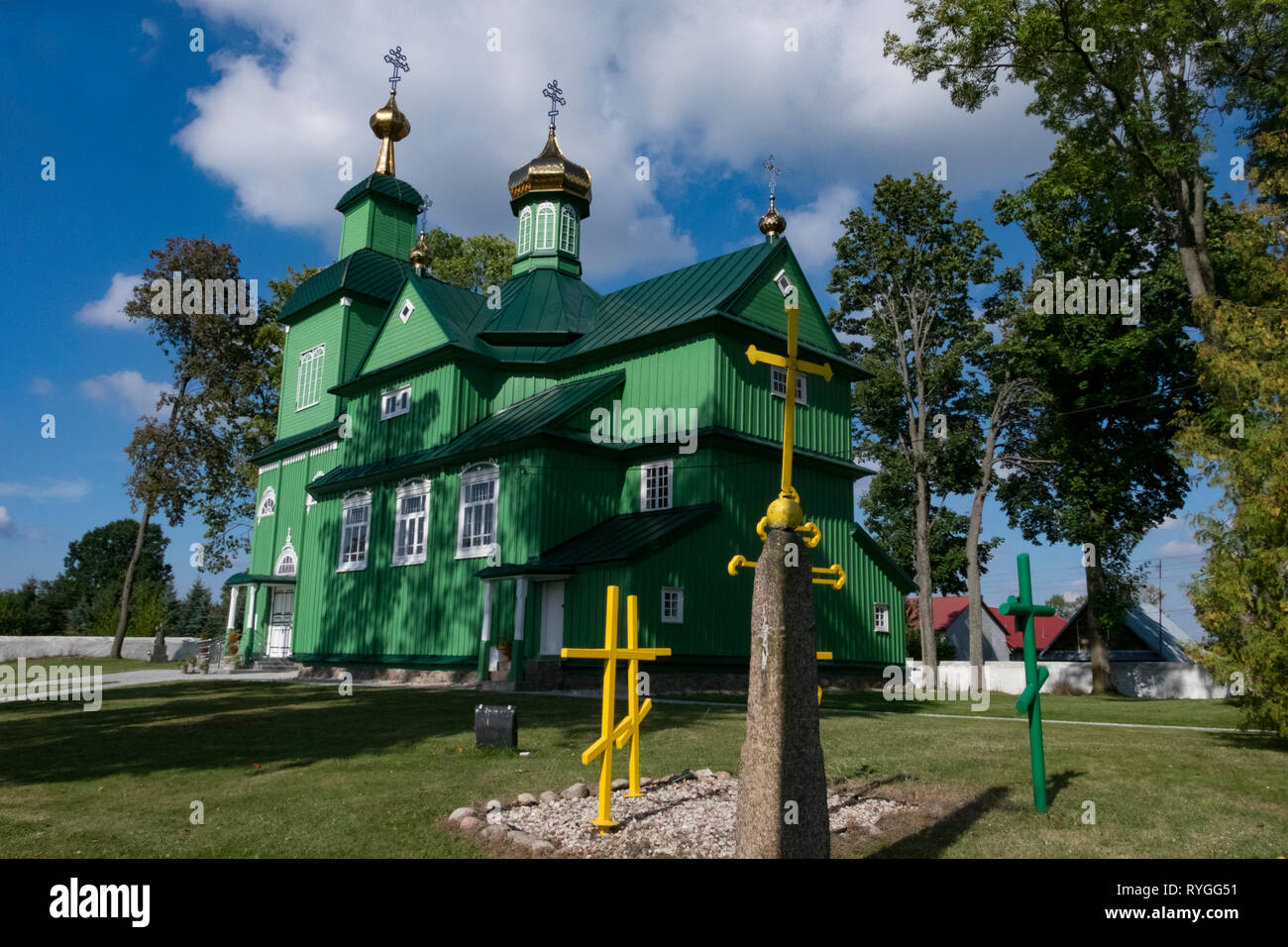 Ruthenian Catholic Church in brilliant green color with multiple crosses and spires on the border between eastern Poland and western Ukraine Stock Photo