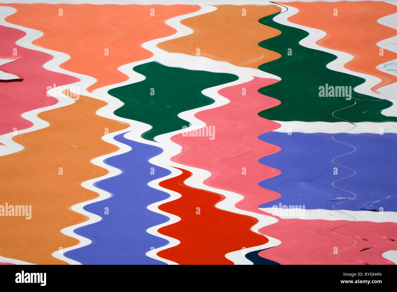 Freeze motion of colorful painted powder exploding on white background. Abstract design of color dust cloud. Particles explosion. Splash of colorful p Stock Photo
