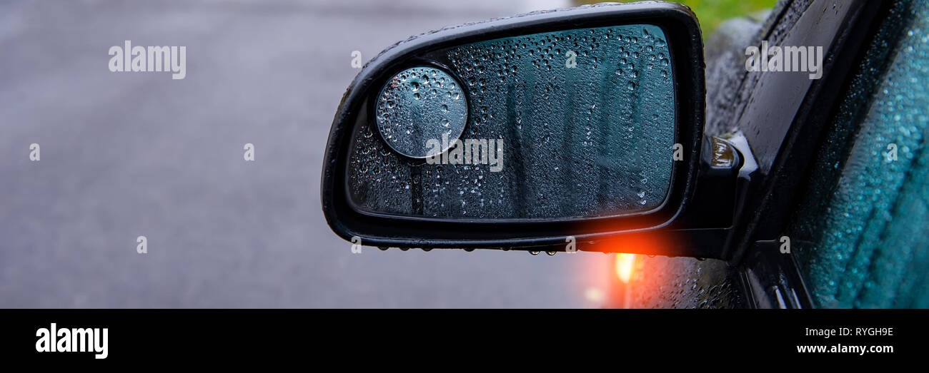 Mirrors And Glass And The Car In The Rain Covered With Drops Of