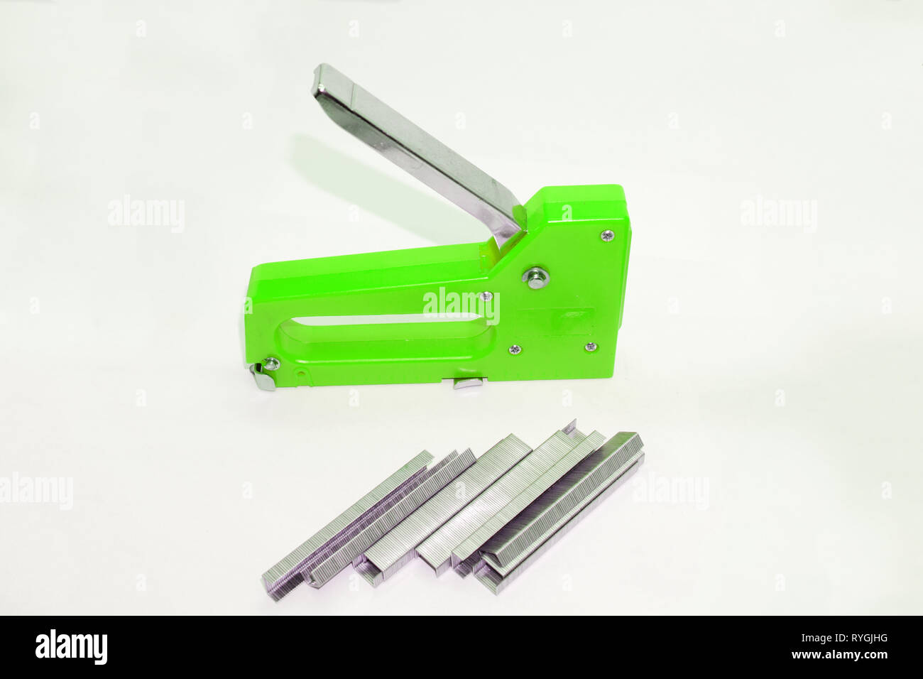 the hand of the worker uses an steel industrial stapler. industrial stapler nailing the leather