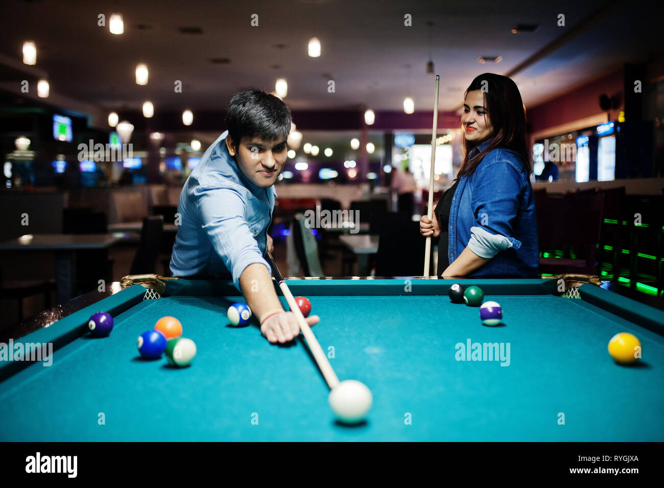 Premium Photo  Friends playing pool at billiard club and shooting