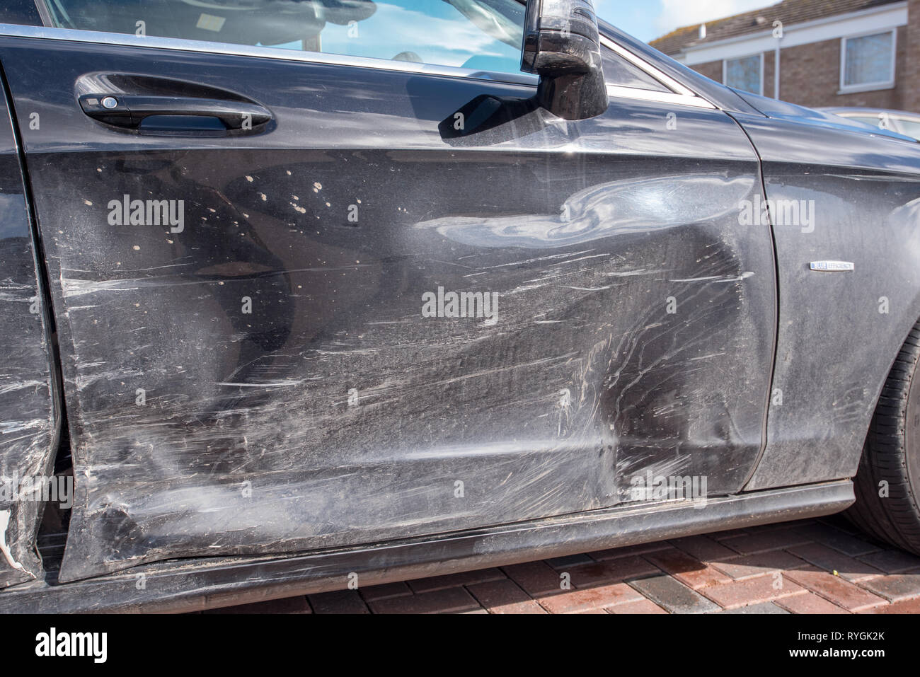 Car crash UK. Close up damage and details after a road traffic accident. Crushed bodywork and tyres. Stock Photo
