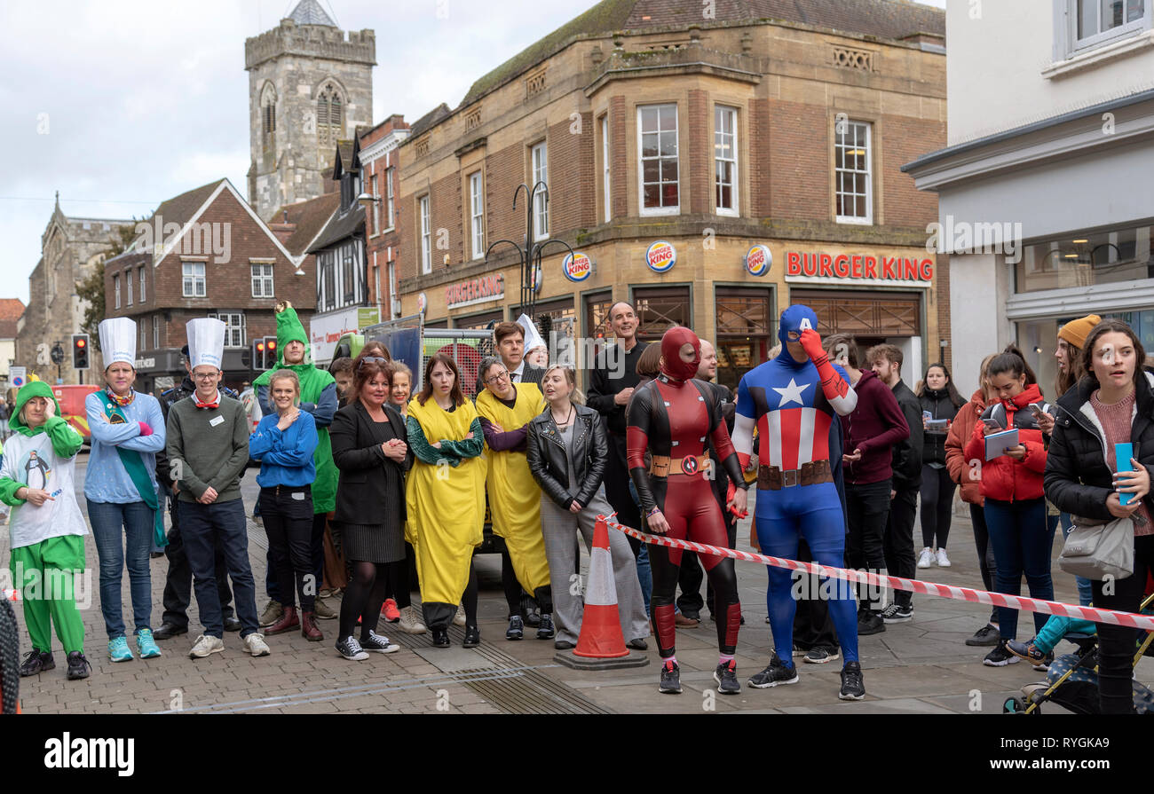Salisbury, Wiltshire, England, UK. March 2019. Pancake race competitors wait for their pancakes and pans on Shrove Tuesday before the race starts. Hig Stock Photo