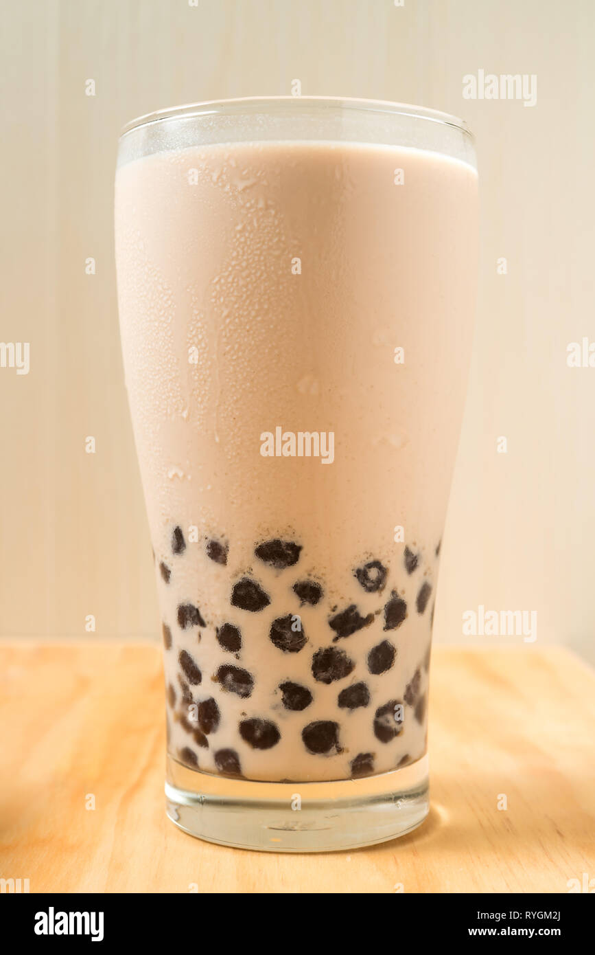 A Glass Cup Of Pearl Milk Tea Also Called Bubble Tea And A Plate Of Tapioca Ball On Wooden Background Pearl Milk Tea Is The Most Representative Dri Stock Photo Alamy