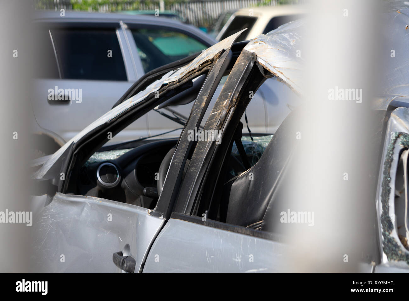 Worker cover car dents with filler material putty by metal spatula. Car