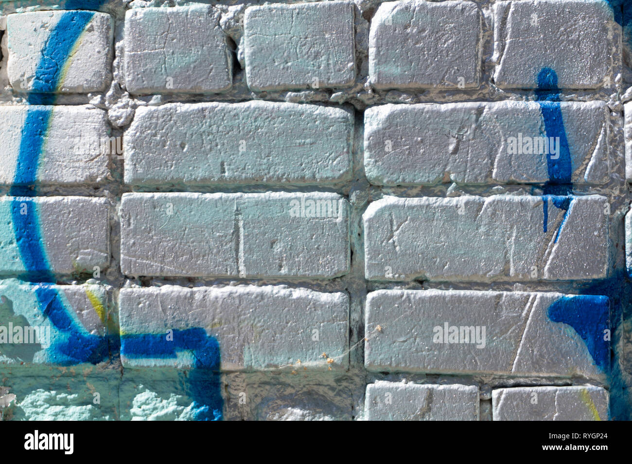Silver painted brick wall texture mortar orange Stock Photo