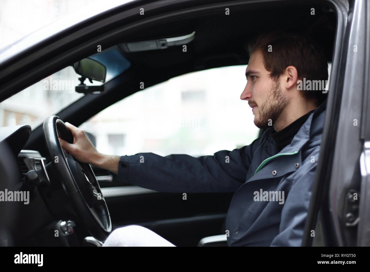 businessman sitting behind the wheel of a car Stock Photo - Alamy