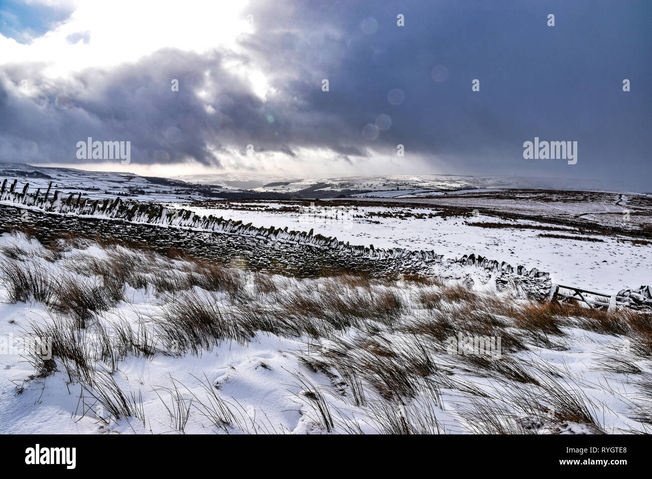 South Pennine Hills in snow, looking from moorland to Hebden Bridge, Crimsworth Dean, Calderdale, West Yorkshire Stock Photo