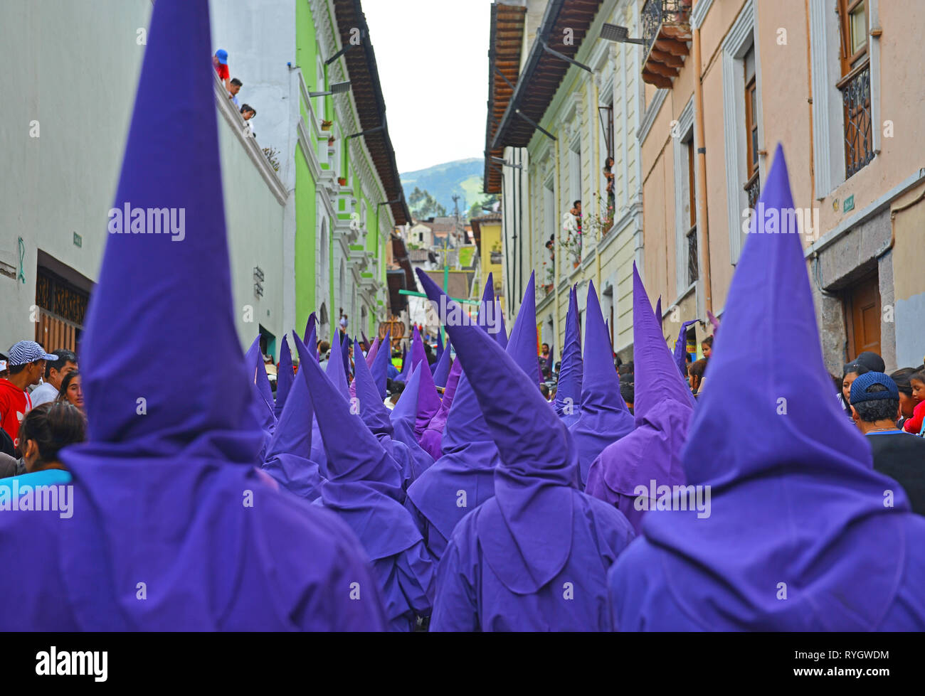 The procession of the cucuruchos in Quito, Ecuador, during Easter. Penitents put a purple robe and walk through the city on Holy Friday. Stock Photo