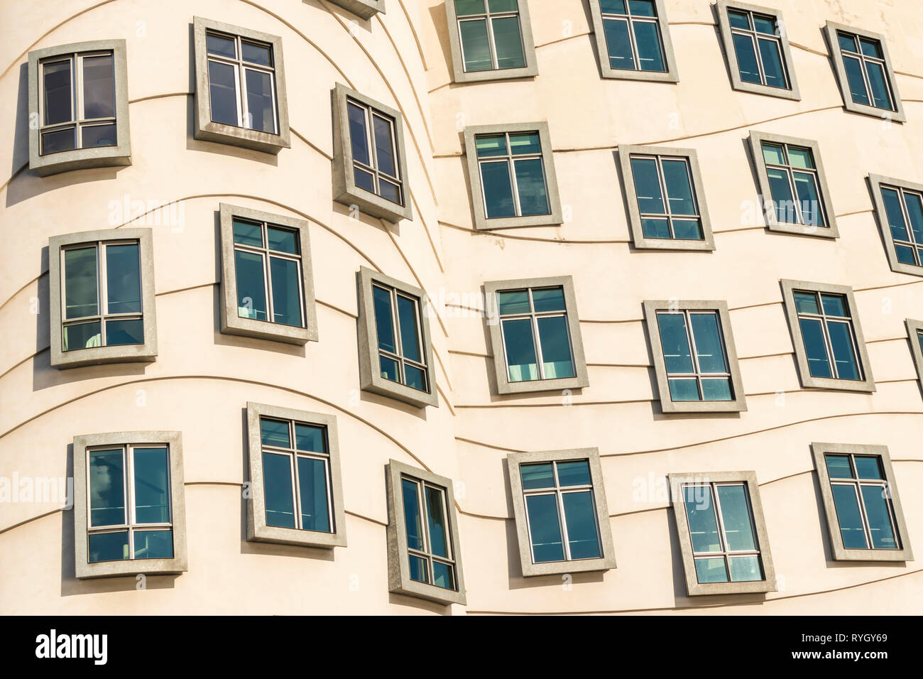 Curvy windows of different shapes on the Tančící dům  Dancing house PRAGUE known as the fred and ginger house Prague CZECH REPLUBLIC EU EUROPE Stock Photo