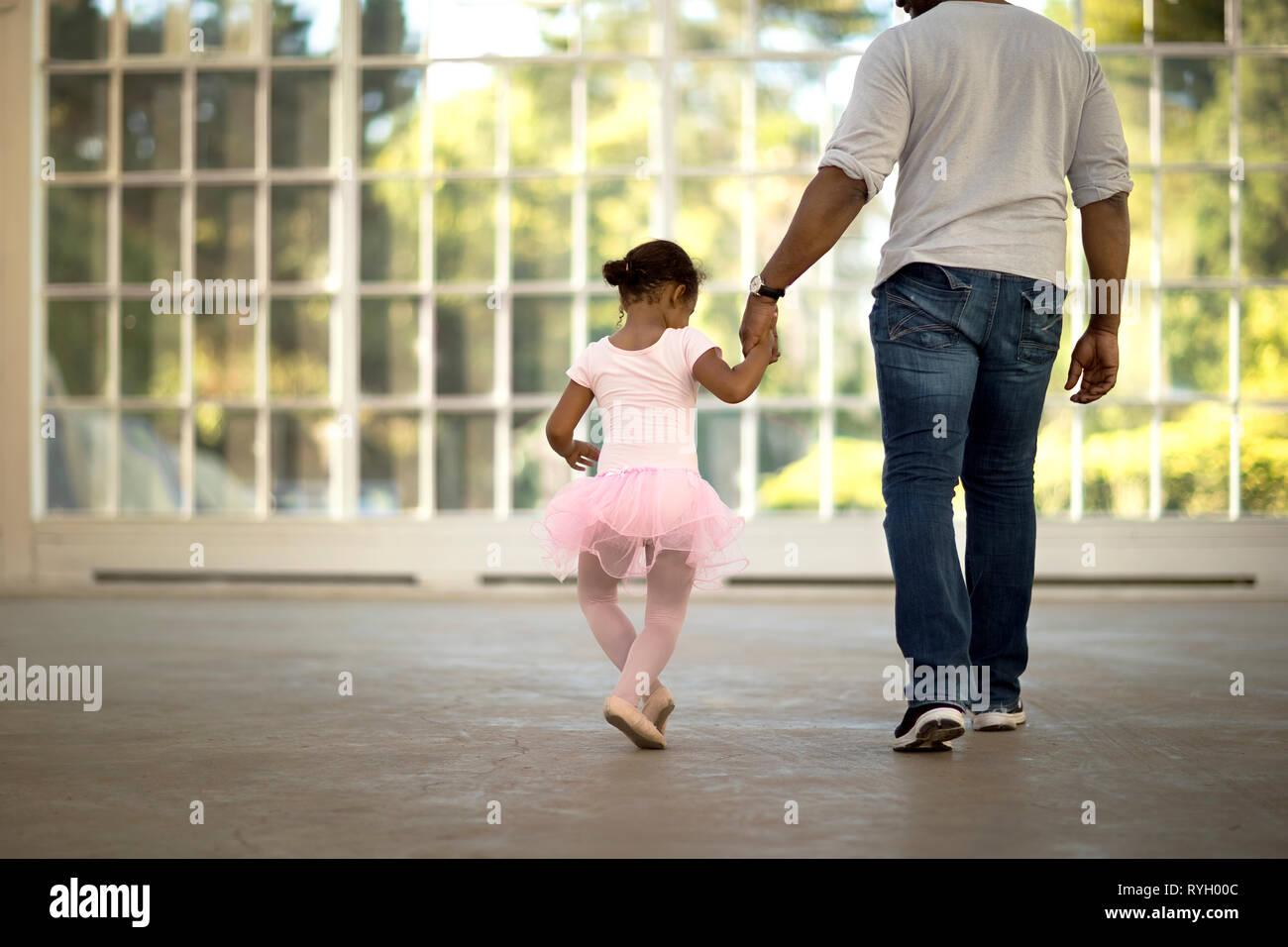 Father And Daughter Holding Hands Walking