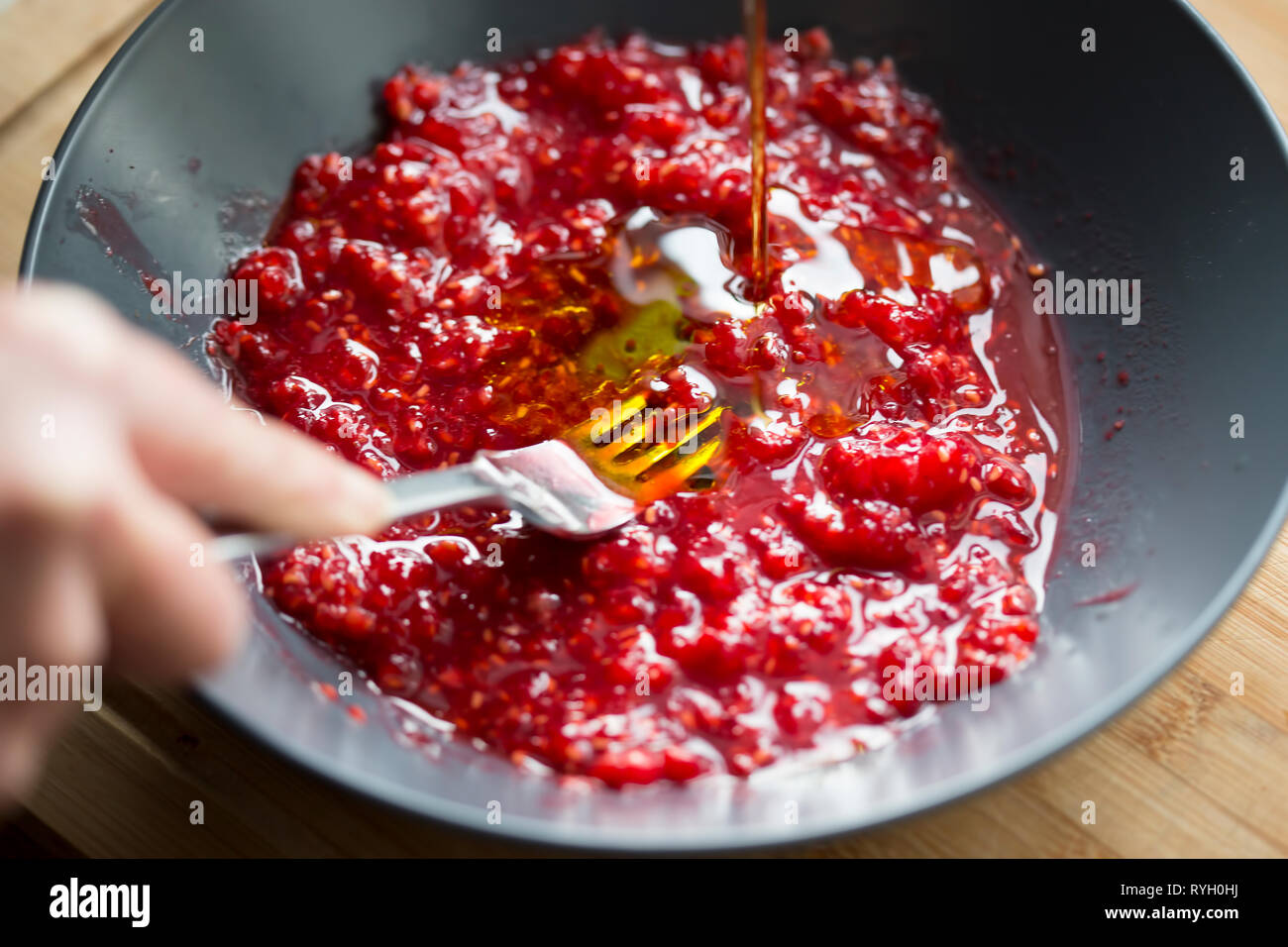 Preparing raspberry vinaigrette dressing Stock Photo