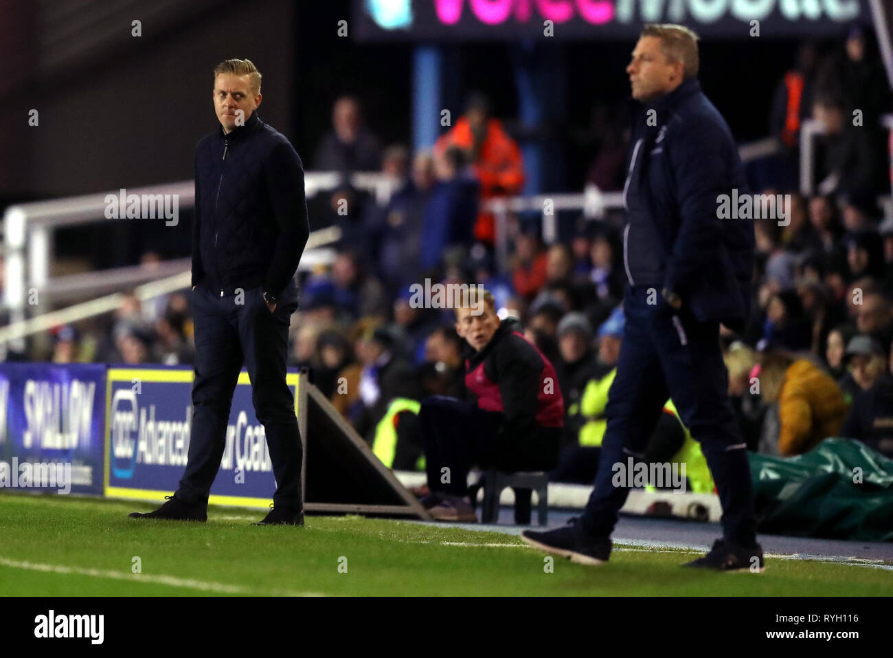 Birmingham City manager Garry Monk (left) and Millwall manager Neil Harris watch match action on the touchline during the Sky Bet Championship match at St Andrew's Trillion Trophy Stadium, Birmingham. Stock Photo
