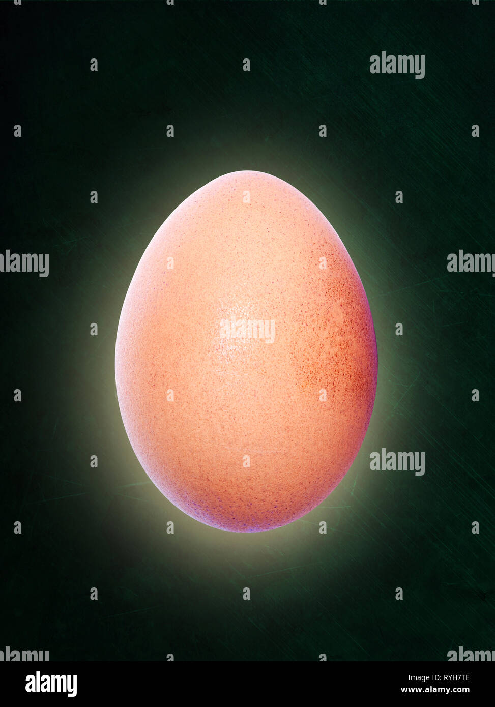 Backlit brown egg floating in midair and isolated on chalkboard background with copy space. Stock Photo