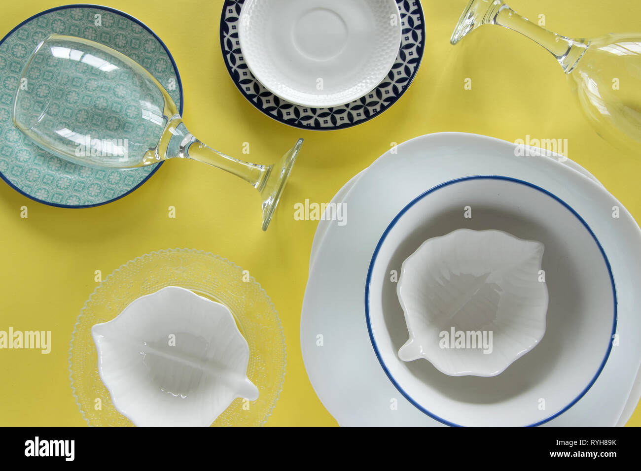 Different porcelain tableware on fresh yellow background Stock Photo ...