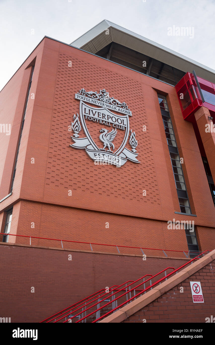 Large imposing silver Liverpool Football Club logo badge emblem sign mounted at height on external brick wall of Main Stand at Anfield Road Stadium UK Stock Photo