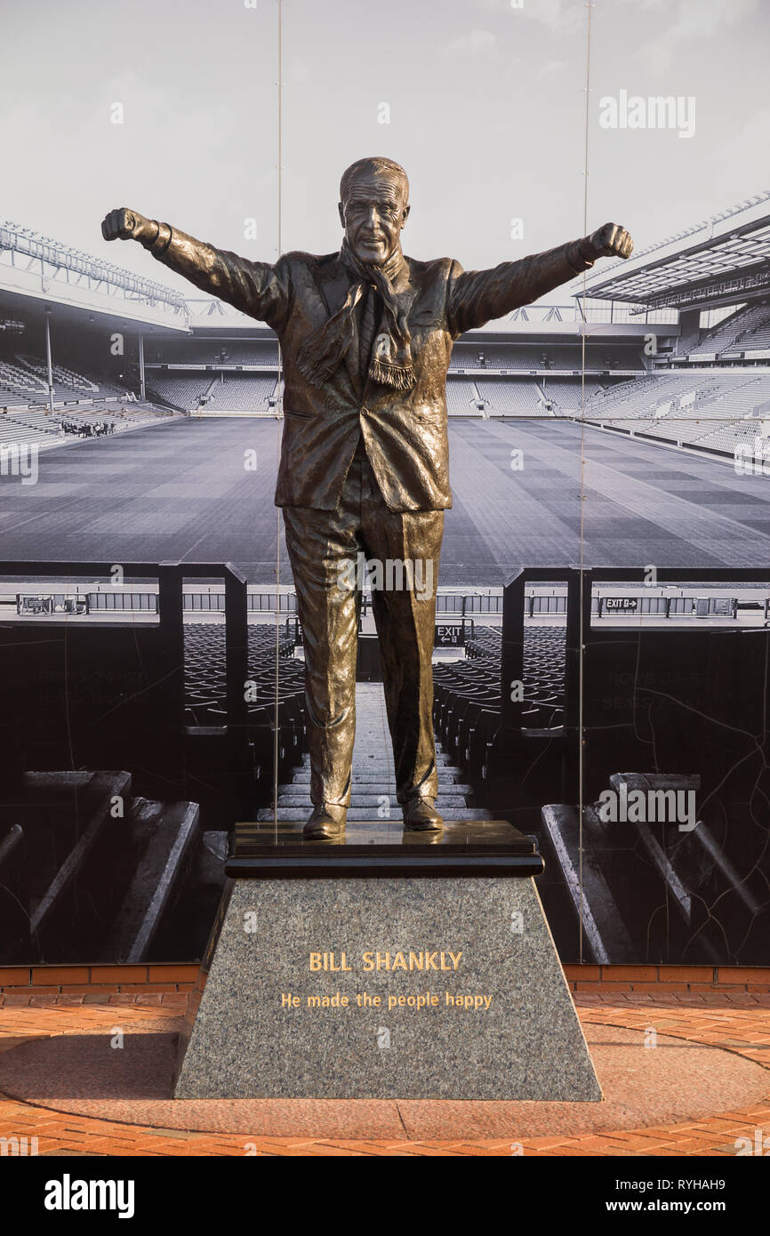 Bronze statue of triumphant Bill Shankly legendary Scottish ex-manager of Liverpool Football Club by Tom Murphy outside The Kop stand, Anfield Stadium Stock Photo
