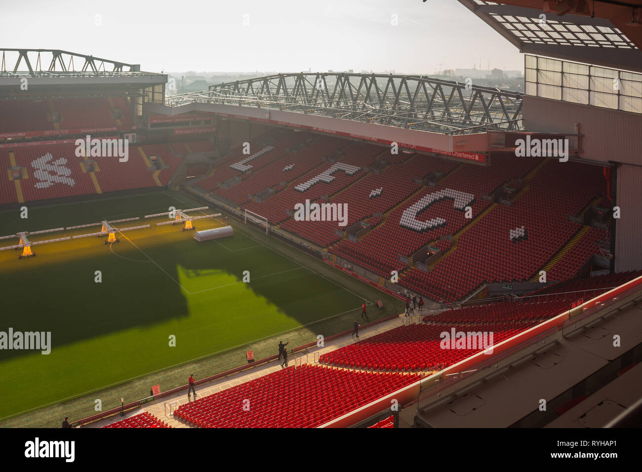 View from Main Stand of the famous Kop end terrace with red seaing tat the south west end of the pitch at Liverpool Football Club Anfield Road Stadium Stock Photo