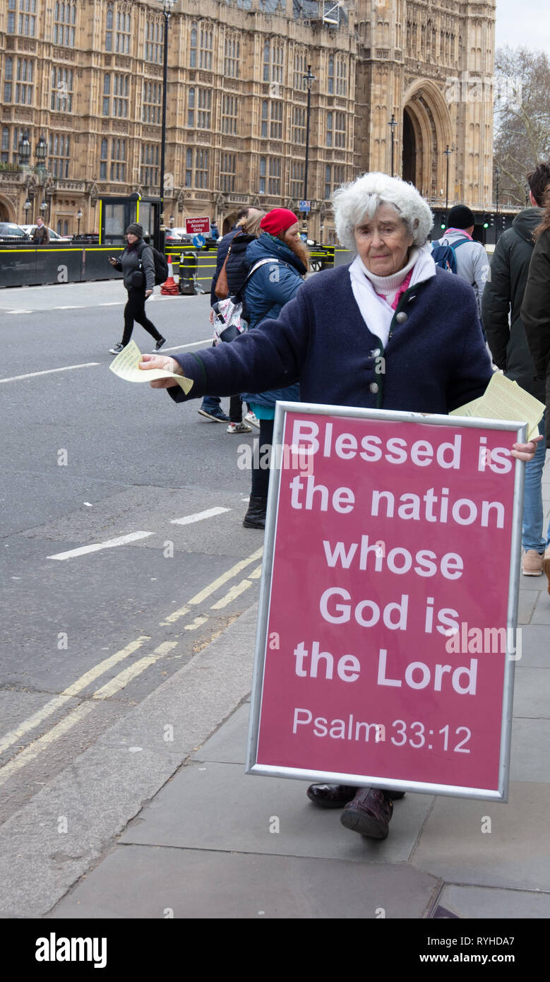 London, UK. 13th March 2019. Member of the Free Methodist Church campaigns for a clean break from the EU outside Parliament in London, UK, today. Credit: Joe Kuis / Alamy Live News Stock Photo