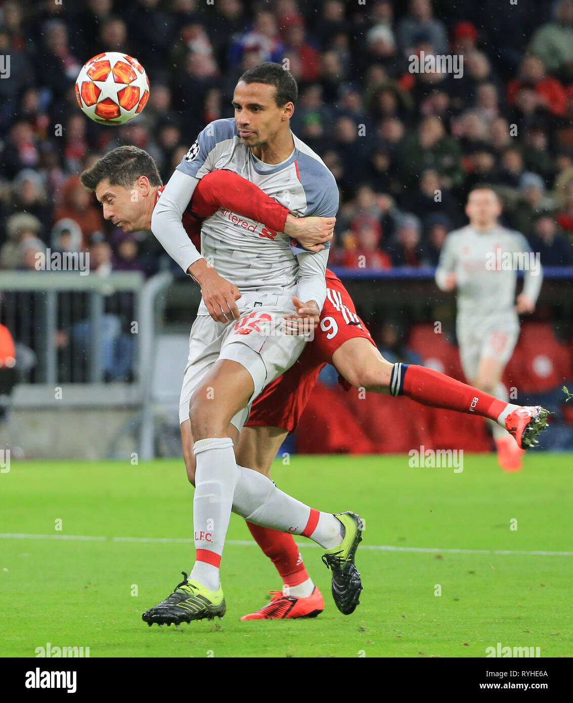 Munich, Germany. 13th Mar, 2019. Liverpool's Joel Matip (front) vies with Bayern Munich's Robert Lewandowski during the UEFA Champions League 1/8 finals second leg match between Bayern Munich of Germany and Liverpool of England in Munich, Germany, on March 13, 2019. Liverpool won 3-1 and advanced into the quarterfinals. Credit: Philippe Ruiz/Xinhua/Alamy Live News Stock Photo
