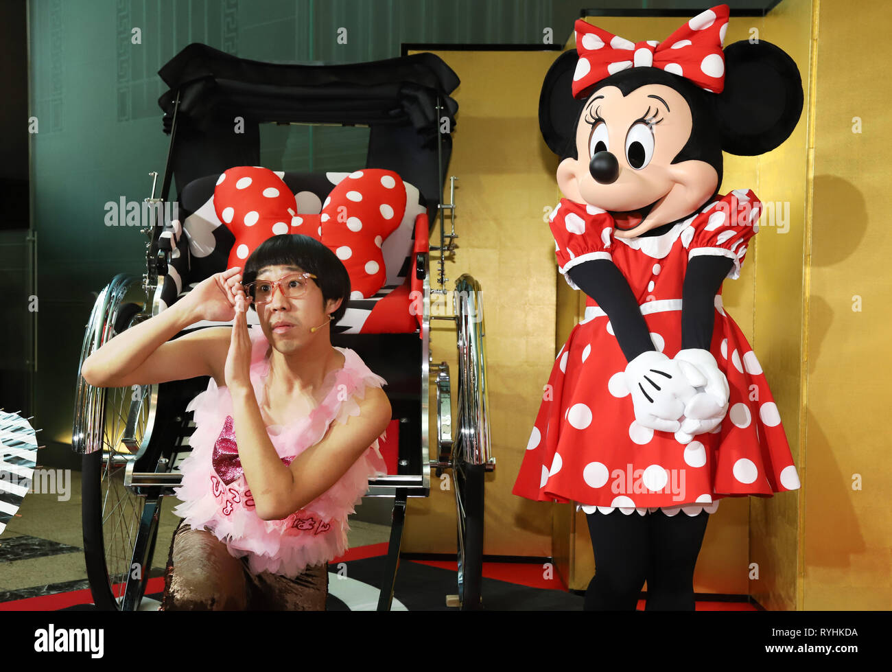 Tokyo, Japan. 14th Mar, 2019. Disney character Minnie Mouse poses with Japanese comedian Hyokkorihan at an opening event for 'Disney Mickey 90th Anniversary, Magic of Color' at the Nihonbashi Mitsui Tower in Tokyo on Thursday, March 14, 2019. Special designed rickshaw with Minnie Mouse motif and 90 Mickey Mouse figures with 90 different colors are displayed at Nihonbashi area from March 15 through 31. Credit: Yoshio Tsunoda/AFLO/Alamy Live News Stock Photo