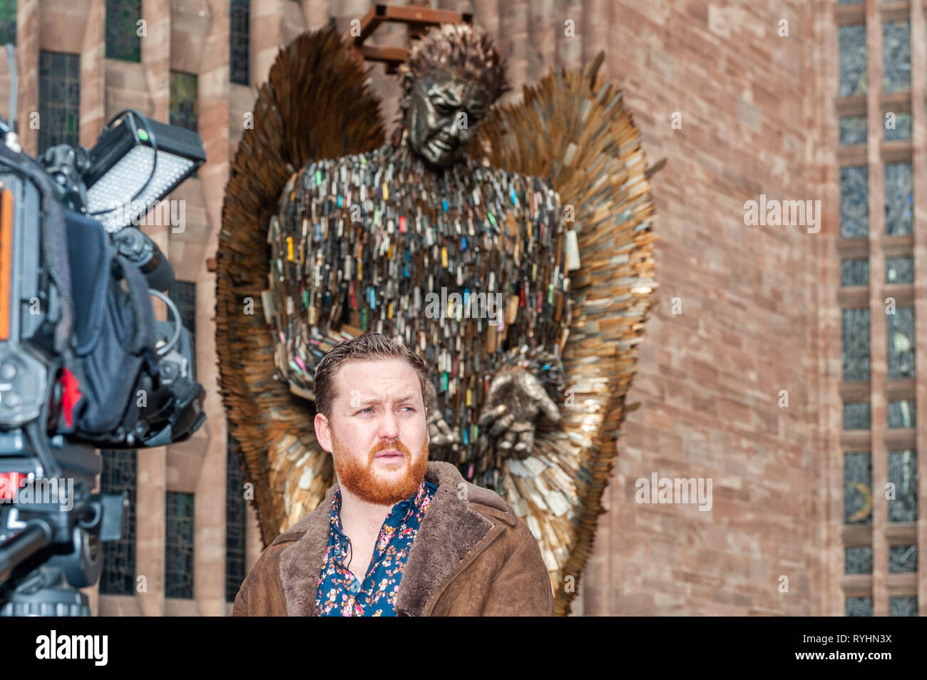 Coventry, West Midlands, UK. 14th March, 2019.  The Knife Angel, which is made up of 100,000 knives which were handed into police forces around the country, was erected outside Coventry Cathedral today. The Knife Angel is a 27 foot high sculpture composed of knives by the artist Alfie Bradley as a physical reminder of the effects of violence and aggression. It is in Coventry until 23rd April. Alfie Bradley, the sculptor responsible for the Knife Angel, was interviewed.  Credit: Andy Gibson/Alamy Live News. Stock Photo
