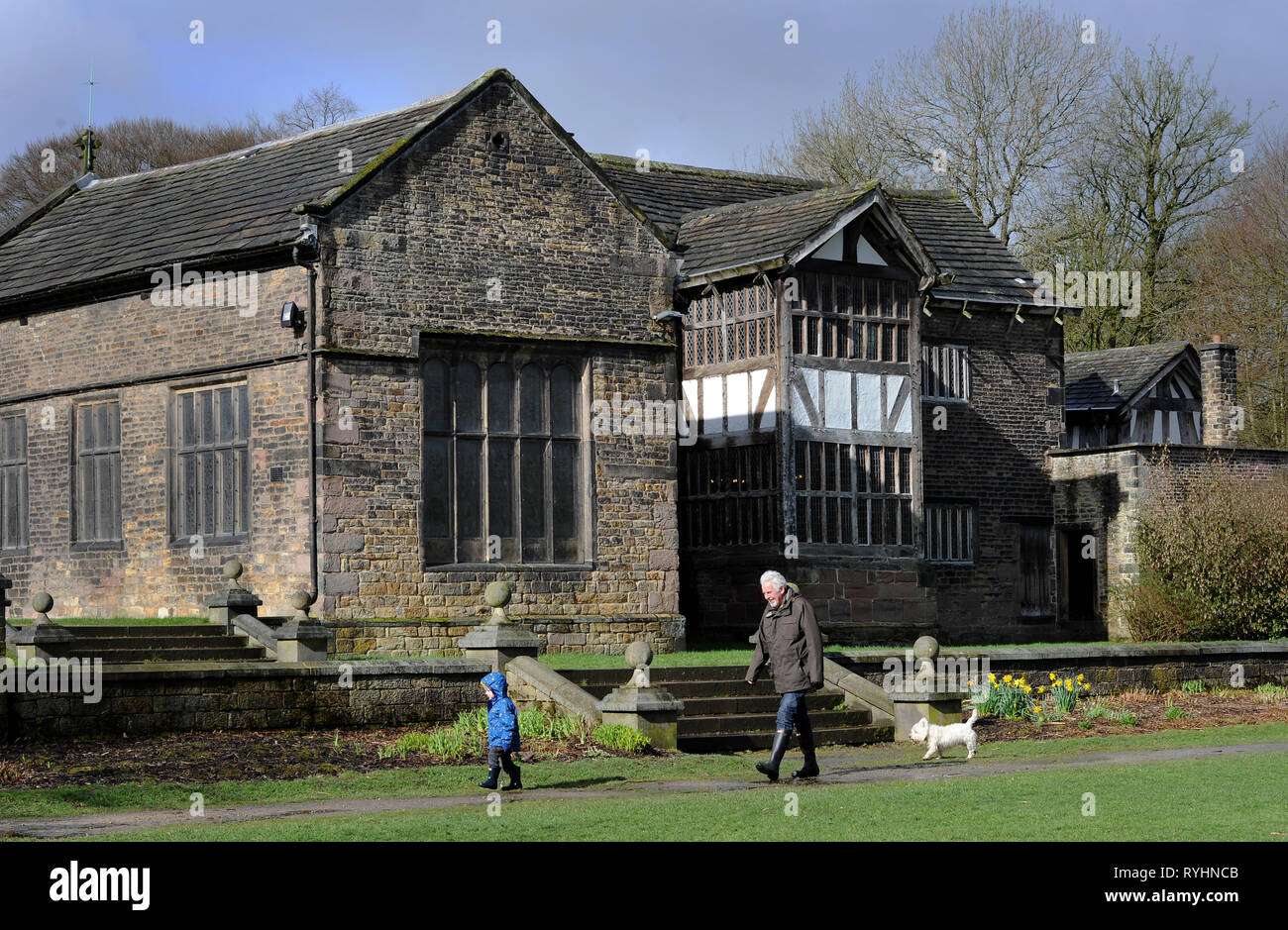 Bolton, Lancashire, UK. 14th Mar, 2019. A mix of sunshine and showers on a blustery day in Smithills Country Park, Bolton, Lancashire. The changeable weather is set to continue until the weekend in the North West of England. A family out for a stroll in the grounds of the historic Smithills Hall. Picture by Paul heres, Thursday March 14, 2019 Credit: Paul Heyes/Alamy Live News Stock Photo