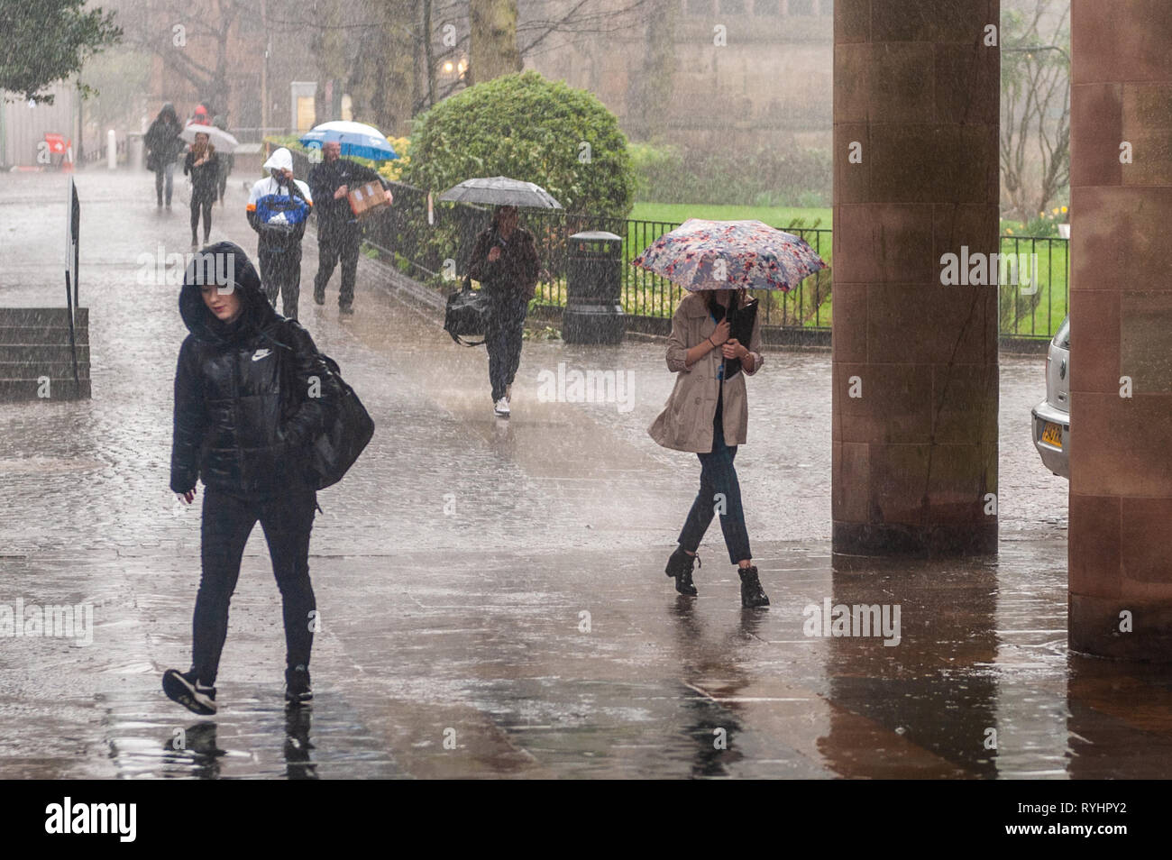 Coventry, West Midlands, UK. 14th March, 2019.  People rush to work in torrential rain which hit Coventry this morning. There will be showers and sunshine for the rest of the day.  Credit: Andy Gibson/Alamy Live News. Stock Photo