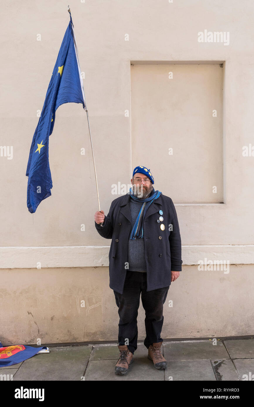 London, UK. 14th Mar, 2019. A pro-remain supporter poses with his Europe flag in Westminster. MPs are due to vote on whether to delay the departure date for Brexit later today. Credit: Stephen Chung/Alamy Live News Stock Photo