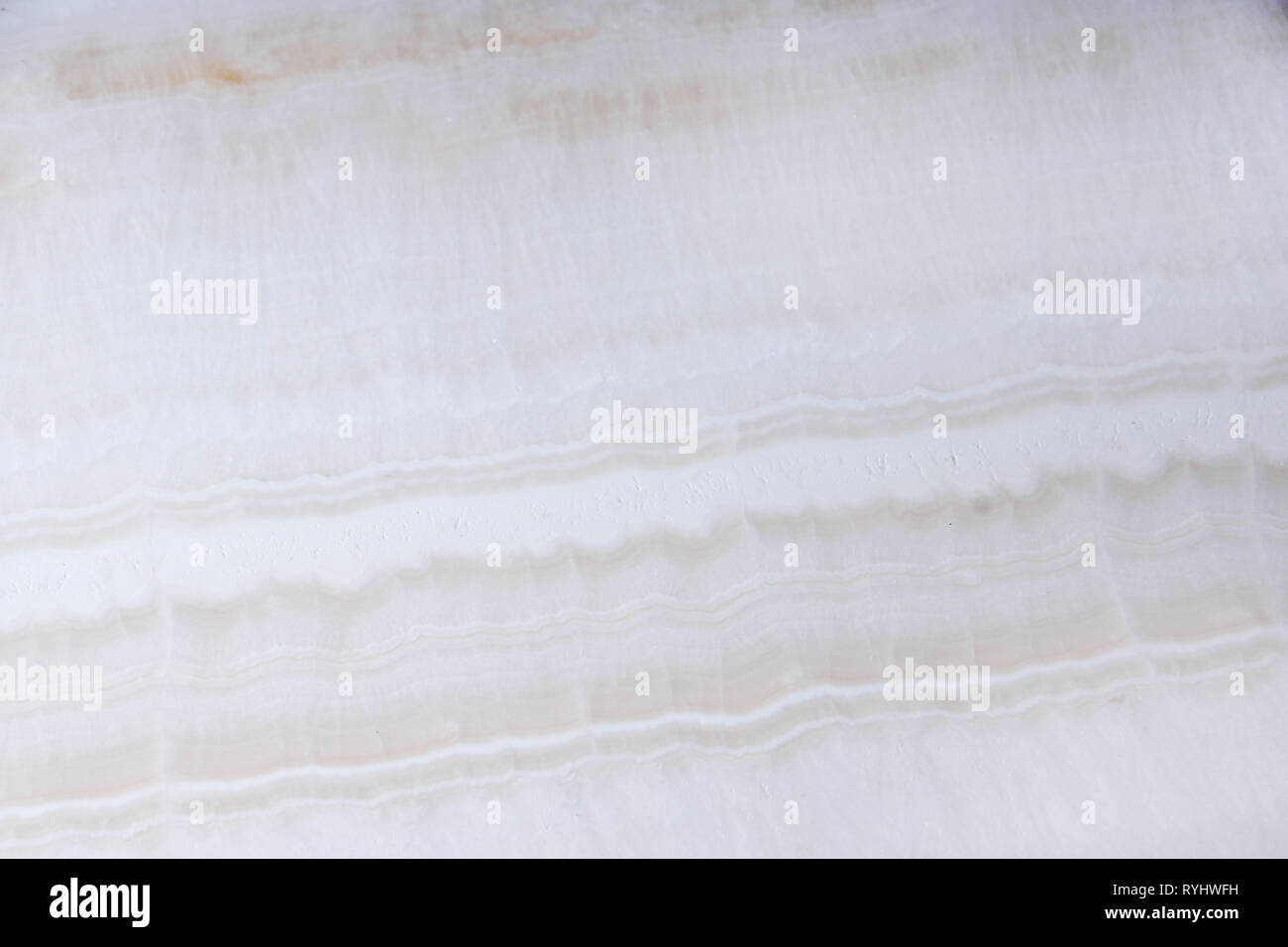Natural white onyx stone with beautiful light waves. Stock Photo