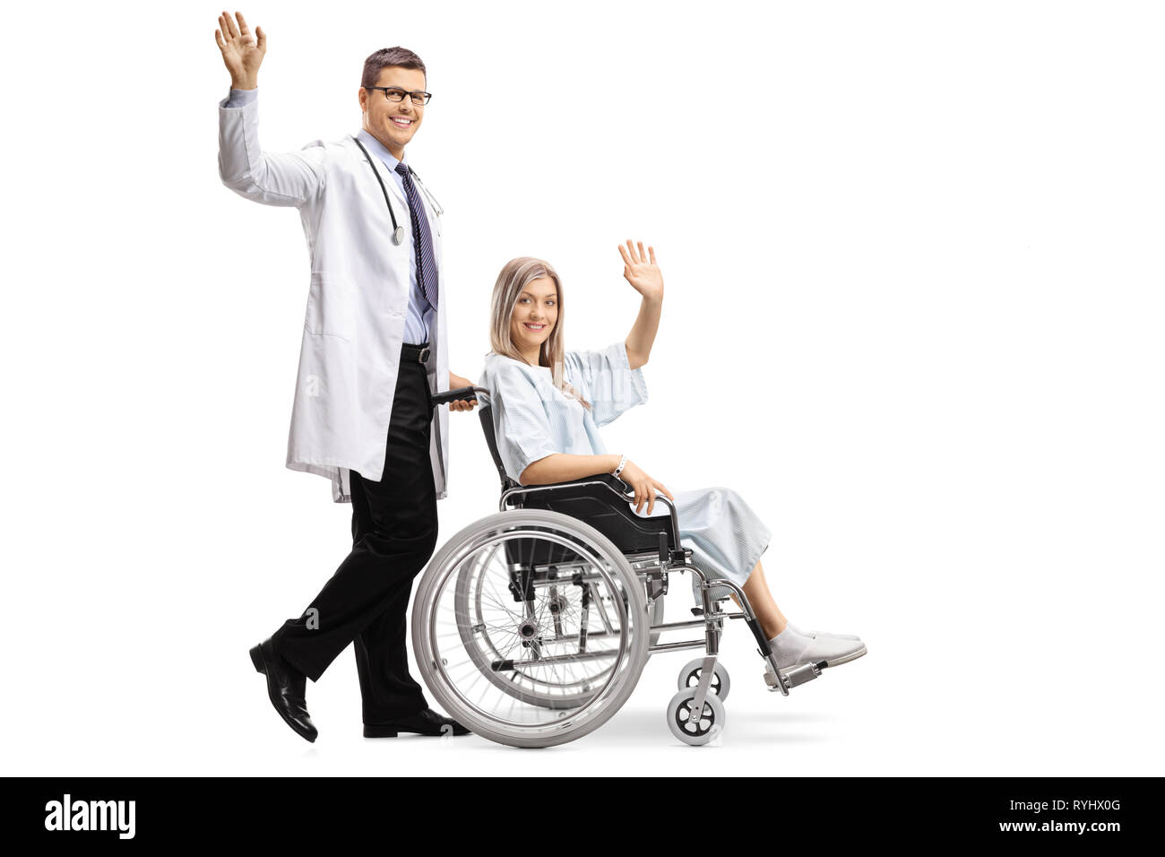 Full length shot of a young male doctor and a female patient in a wheelchair waving isolated on white background Stock Photo
