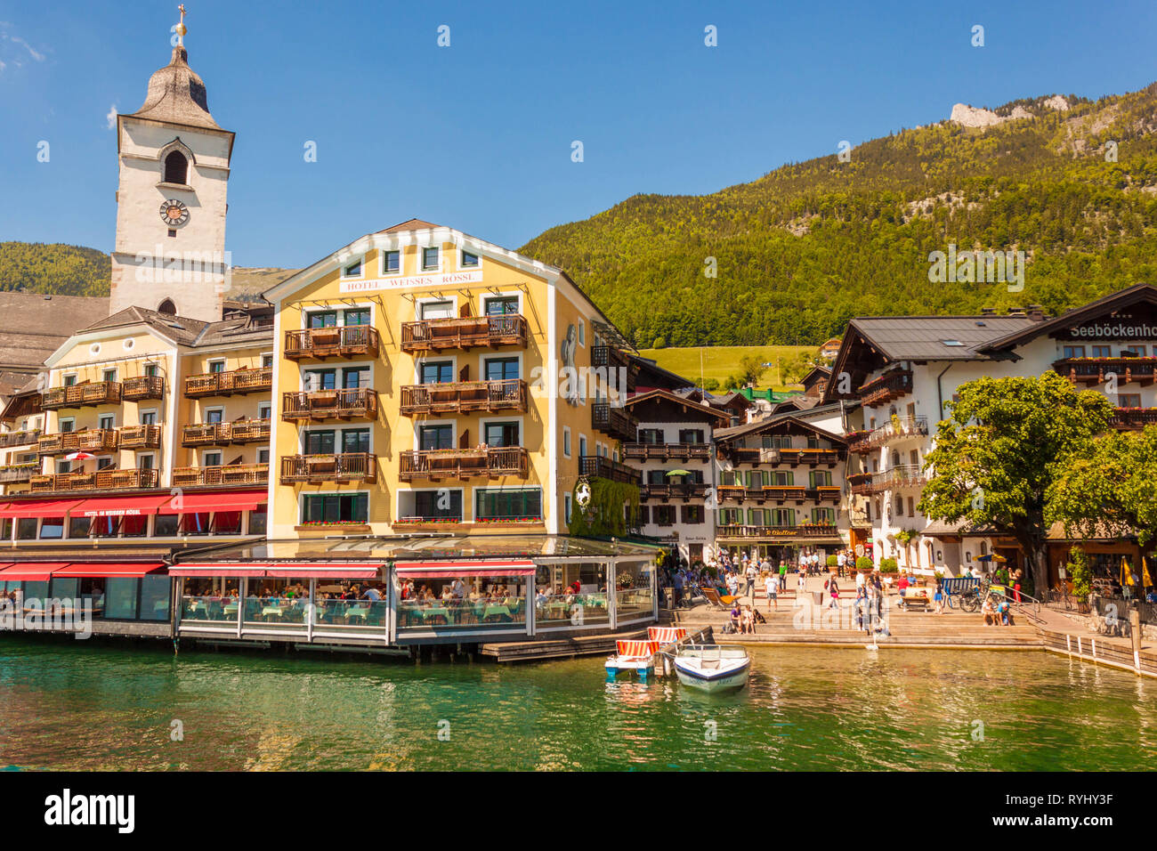 St.Wolfgang, Austria - May 27, 2017: Lakeside sqaure and restaurants of popular austrian town are full of people. Famous White Horse Inn Stock Photo