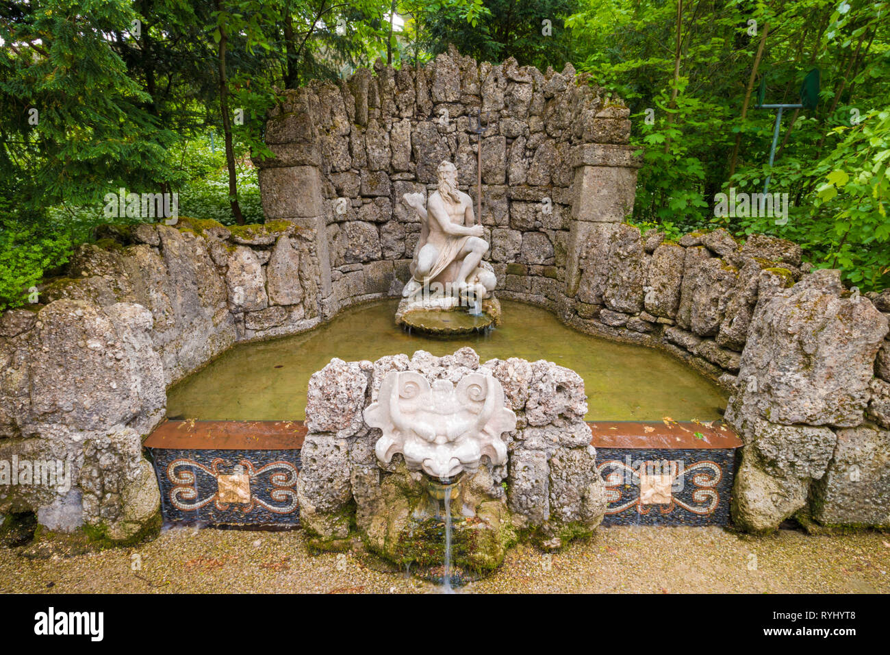 Salzburg, Austria - April 30, 2018: Trick fountain and sculpture of Neptune in water trick park of  Hellbrunn (Schloss Hellbrunn), Salzburg, Austria. Stock Photo