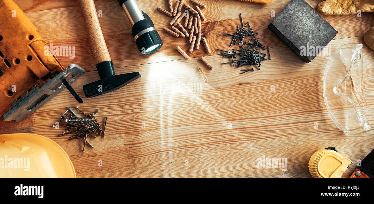 Carpenter woodwork workshop desk top view mock up with various tools around blank copy space of pine wood material Stock Photo