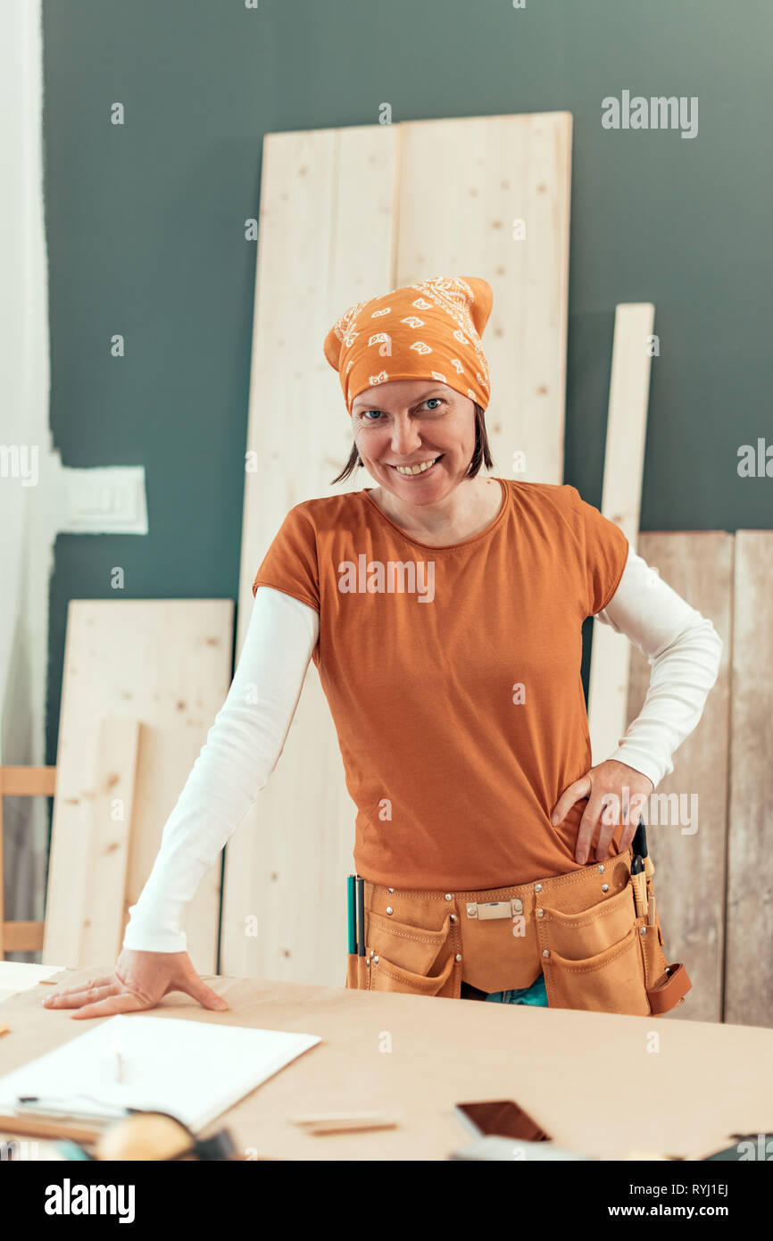 Self employed female carpenter smiling portrait in her small business