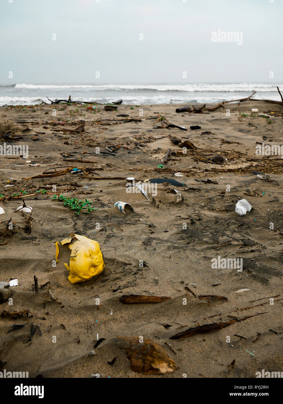 a broken yellow plastic piggy bank trash on a beach in the caribbean ocean near Cartagena colombia Stock Photo