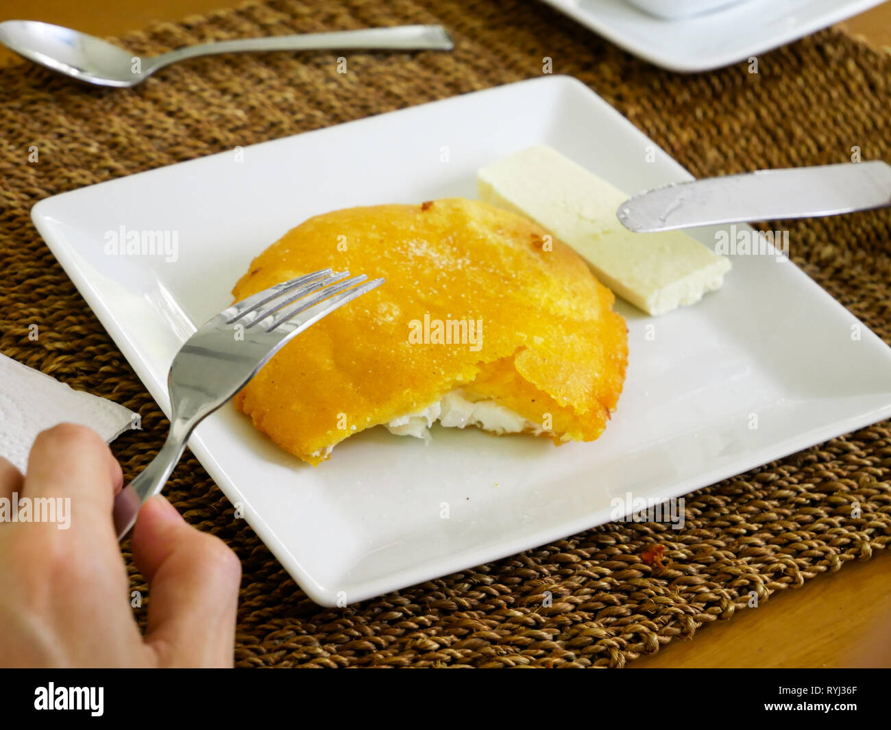 woman having arepa de huevo for breakfast a typical food of the