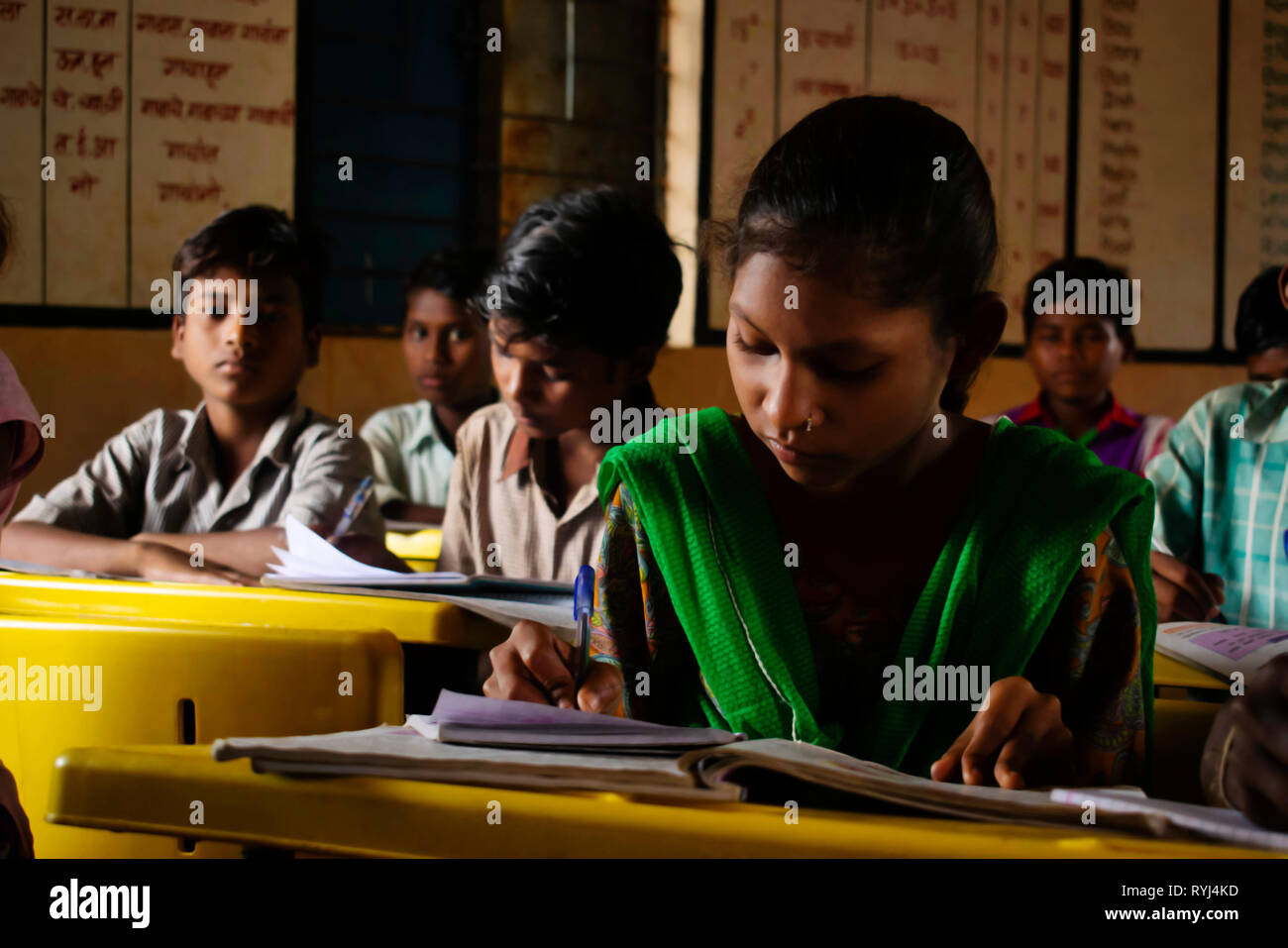 AMRAVATI, MAHARASHTRA, INDIA, August 2018, Girl writing at her desk at primary school at Ghuti Village, Dharni Taluka Stock Photo