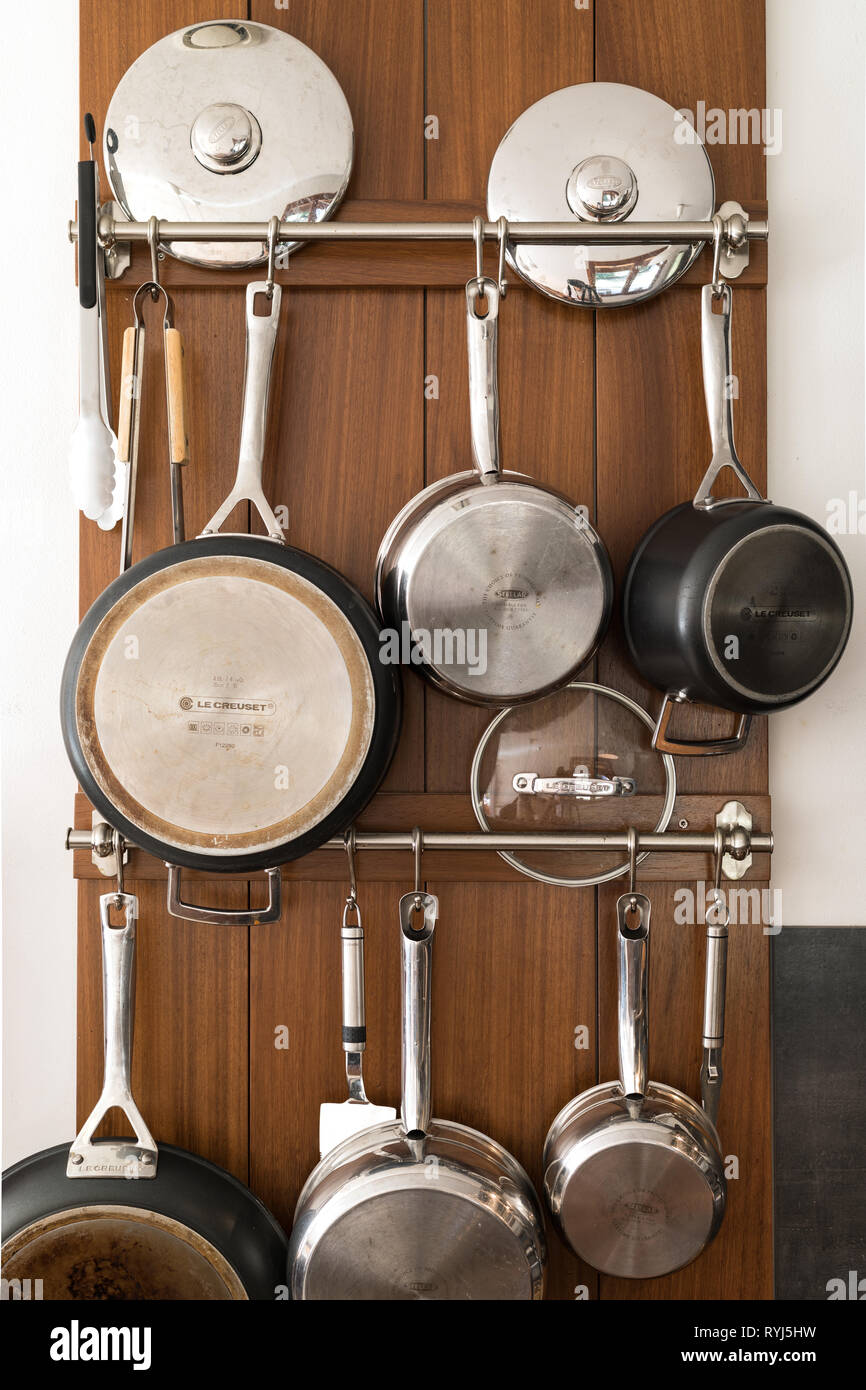 Hanging pots and pans on the wall. Stock Photo