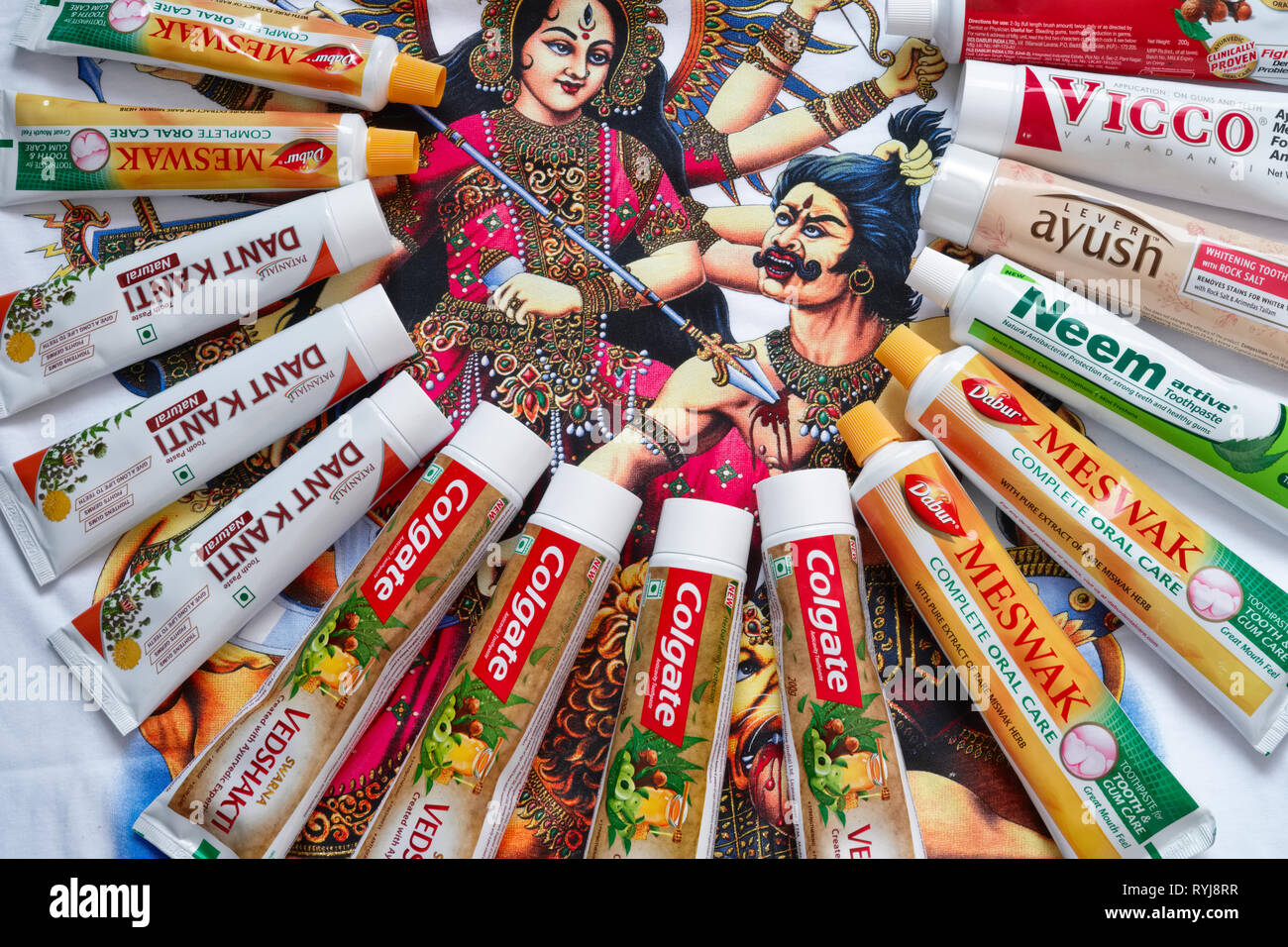 Various brands of Indian Ayurvedic toothpastes, spread out on a Tshirt